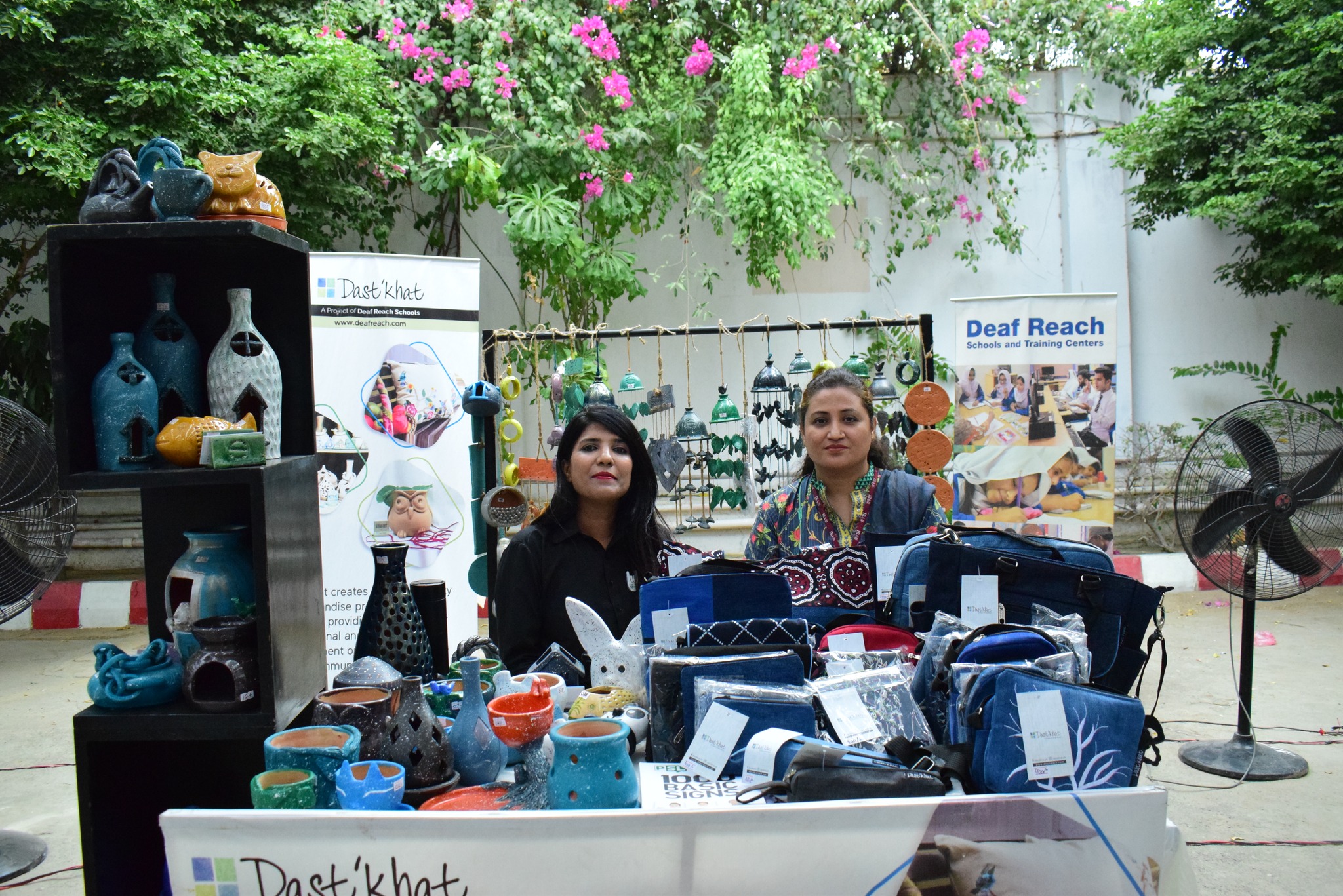 Founders displaying handmade ceramics and craft products